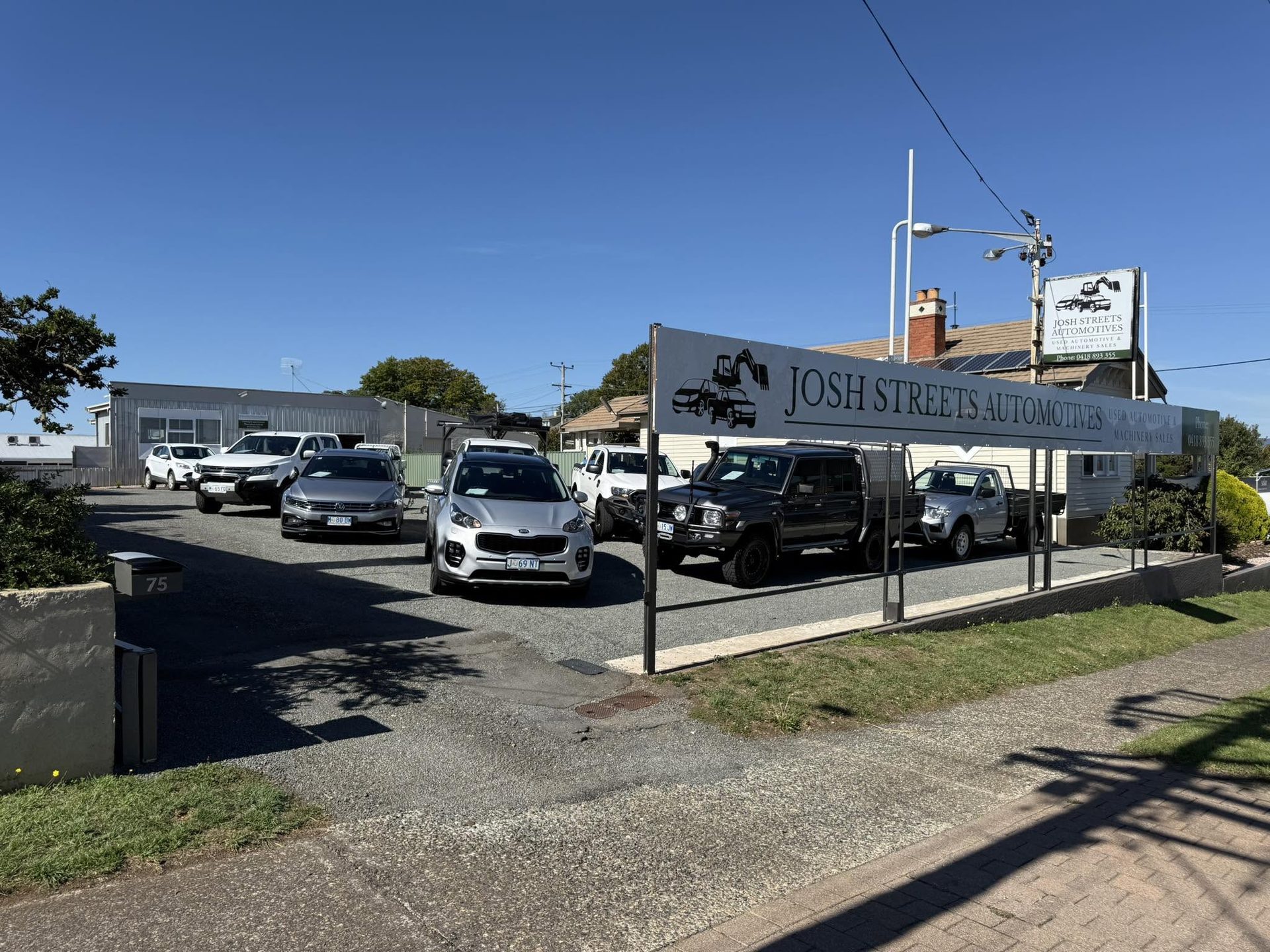 The Josh Streets Automotives sign and yard on Emu Bay Road, Deloraine
